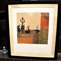 Framed art print titled "Impressions Of Paris" with visible numbering and signature, showing full view of framed piece including water bottle for scale.