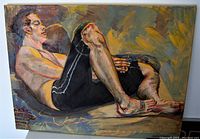Full view of "The Lounger" painting showing the reclining male figure on canvas with expressive brushstrokes and warm tones, signed by Monika Uesson Talpak.