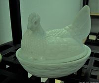 Milk glass hen on nest covered bowl, white opaque glass with textured feather and nest details.