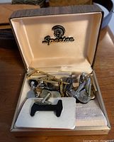 Spartan presentation box containing cuff links and tie pins with logo on lid interior
