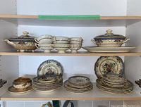 Shelves containing stacked Royal Doulton Vernon dinnerware including plates, lidded bowls, and gravy bowls showing full lot assortment.