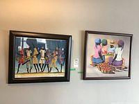 Two framed paintings hung side by side on a wall, one depicting seated women with baskets of fruit and the other showing six walking figures in patterned dresses.