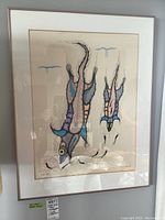 Front view of framed artwork hung on wall, showing abstract fish design and frame condition