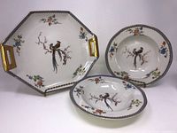 Set of three Theodore Haviland Limoges Paradise porcelain pieces: octagonal platter with gold handles, two bowls with matching bird and floral decoration.