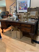 Front view showing overall desk design, drawers and carved detailing