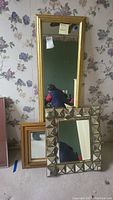 Three mirrors grouped with visible different frame styles and sizes