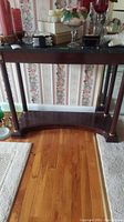 Wooden table from front showing table structure, legs, bottom shelf, and marble top. Surrounding items not included.