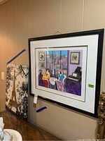 Framed Sarinson 3D picture and Eiffel Tower canvas leaning against wall