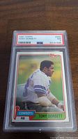 Front view of 1981 Topps Tony Dorsett card in PSA slab showing grade 7 label and card image.