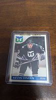 Front view of Kevin Dineen rookie hockey card showing player image in Hartford Whalers uniform and rookie card designation.