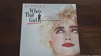 Front cover of Madonna Who's That Girl soundtrack vinyl record showing Madonna's face and text title.