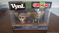 Front view of the original box showing VNYL branding, Gremlins logo, and enclosed Gizmo and Stripe figures.