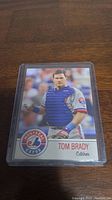 Front view of the Tom Brady baseball card in Montreal Expos catcher uniform in clear protective case showing player image and card design.