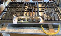 Full front view of Frigidaire Professional gas countertop stove with five burners and control knobs.