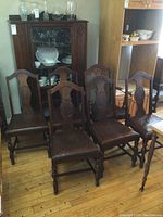 Six Gibbard dining chairs arranged in front of cabinetry