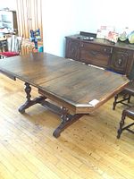 Photo of the vintage Gibbard dining table fully extended with leaf inserted, showing the overall table size and shape.