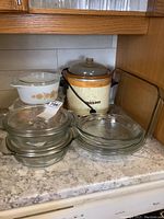 Overview photo showing all glass bakeware and the crock pot grouped on countertop.