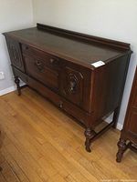 Left angled view of the vintage sideboard showing front and side details.