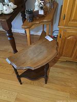 Photo of the smaller D-shaped end table showing water marks and overall condition.