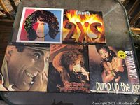 Five vintage vinyl LPs laid out showing front covers with distinct album art for identification and condition assessment