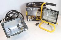 Two halogen workshop lamps photo showing a yellow 500 watt lamp with original box and a gray lamp without bulb.