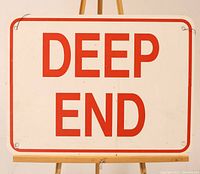 Front view of the vintage enamelled metal rectangular sign with 'DEEP END' in red letters on a white background and red border.