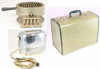 Photo showing the round metal food warmer with black wood handle, chrome toaster with fabric cord, and green checked picnic hamper.