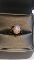 Front view of ring showing oval purple opal and split shank setting