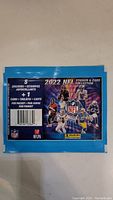 Front of a sealed 2022 NFL sticker and card pack showing 5 stickers and 1 card per pack with NFL players and logos.