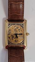 Front view of skeleton dial and black hands
