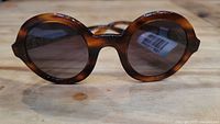 Front view of round tortoiseshell frame and grey lenses