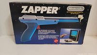 Front of original NES Zapper box showing product name and branding.