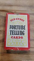 Photo of the red and white box labeled Old Gypsy Fortune Telling Cards showing condition and design of packaging