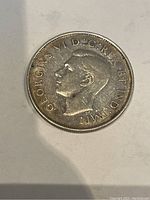 Obverse side of the 1944 Canadian 50 cent coin showing King George VI profile with inscriptions.