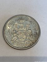 Obverse side of the 1962 Canadian 50 cent silver coin showing the Canadian coat of arms.