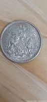 Reverse side of the coin showing the Canadian Coat of Arms with denomination and year.