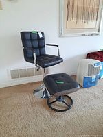 Black faux leather high bar stool and ottoman set in living room setting, showing side angle with chair and ottoman close together