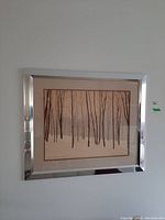 Framed limited edition print depicting leafless trees in winter with signature and number visible