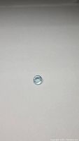 Photo of natural aquamarine gemstone front view on plain background