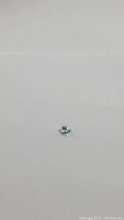 Close-up photo of 2.10ct oval cut aquamarine stone on white background