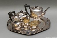 Photo of entire silver plated 5-piece tea and coffee set on a tray with handles, showing all items in lot