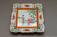 Front of the hand painted square porcelain plate with traditional Chinese scene and floral border.