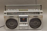 Front full view of vintage SANYO M9935K boombox showing cassette player, speakers, radio frequency display, and controls.