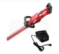 Red Shindaiwa hedge trimmer with battery attached and charger unit