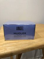 Front of the box showing product name, brand, size 200 ml and label indicating it is a perfuming body cream.