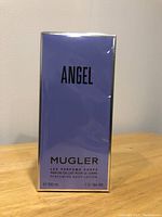 Front view of sealed and new 200 ml Angel body lotion by Mugler in lavender box packaging.