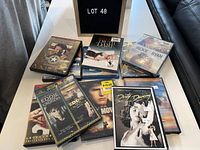 Image of assorted DVD cases arranged on table including titles Dirty Dancing, Eddie Cruises, Jackie Ryan, and others.