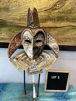 Front view of the Venetian Carnival mask showing the split-colored face, jester points, card collar, and decorative pole.