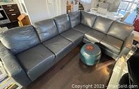 Front view of L-shaped navy leather sectional showing overall shape and color