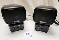 Pair of Aiwa SC B10 DSL BBE speakers mounted on base units with front mesh covers, showing size and label details.